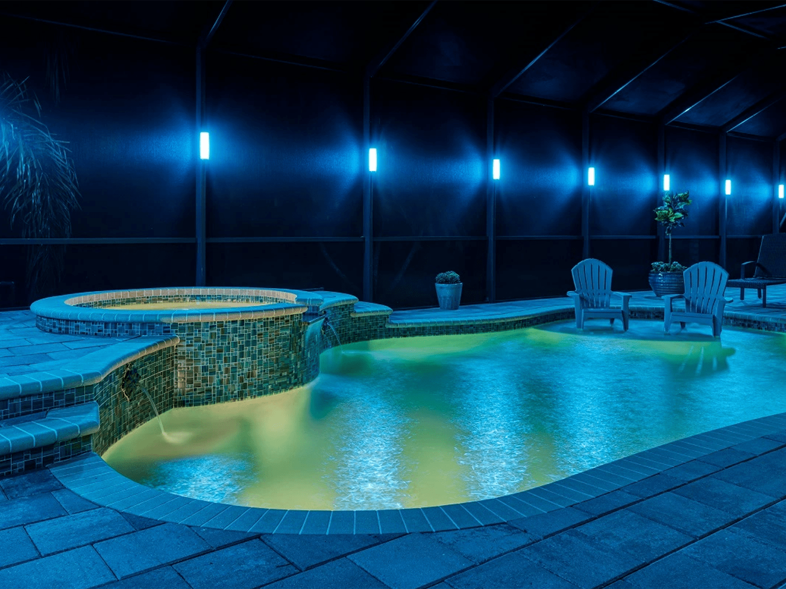 pool exterior illuminated with outdoor lights