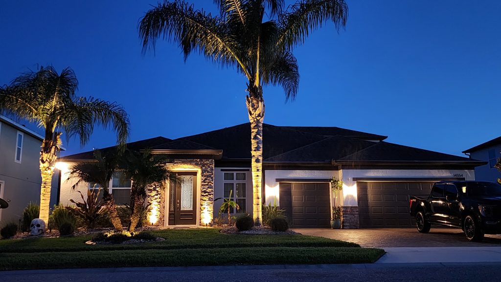 Home illuminated with Residential landscape lighting